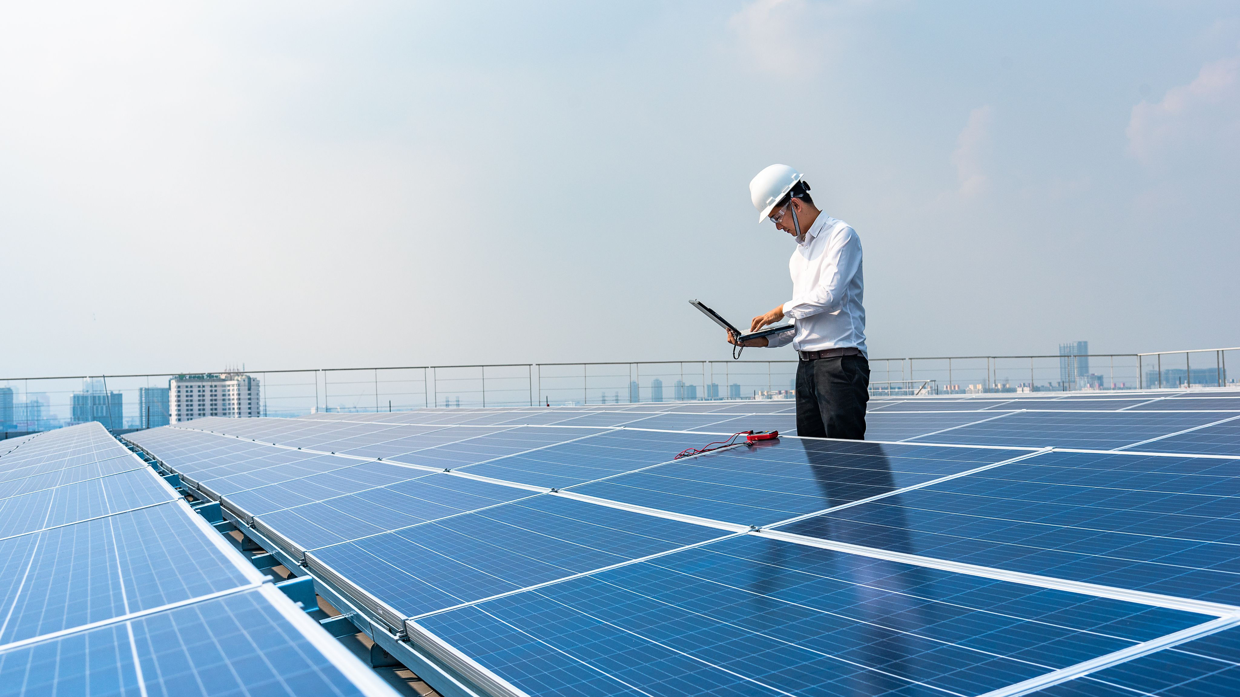 Worker checking on solar panels